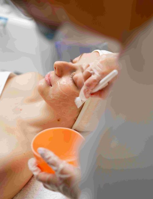 cosmetologist-applying-peeling-mask-on-woman-s-fac-2024-12-04-18-43-46-utc